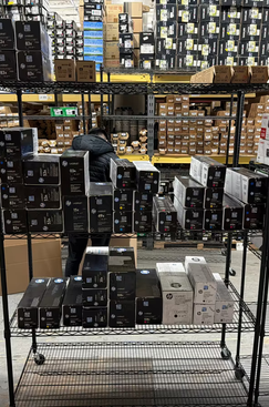 toner cartridages on metal shelf